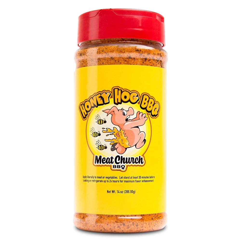 A 14-ounce jar of Meat Church Honey Hog BBQ Rub. The label is yellow with red text and features a cartoon pig breathing fire, surrounded by bees. The jar has a red lid and contains a coarse, reddish-brown spice mix.