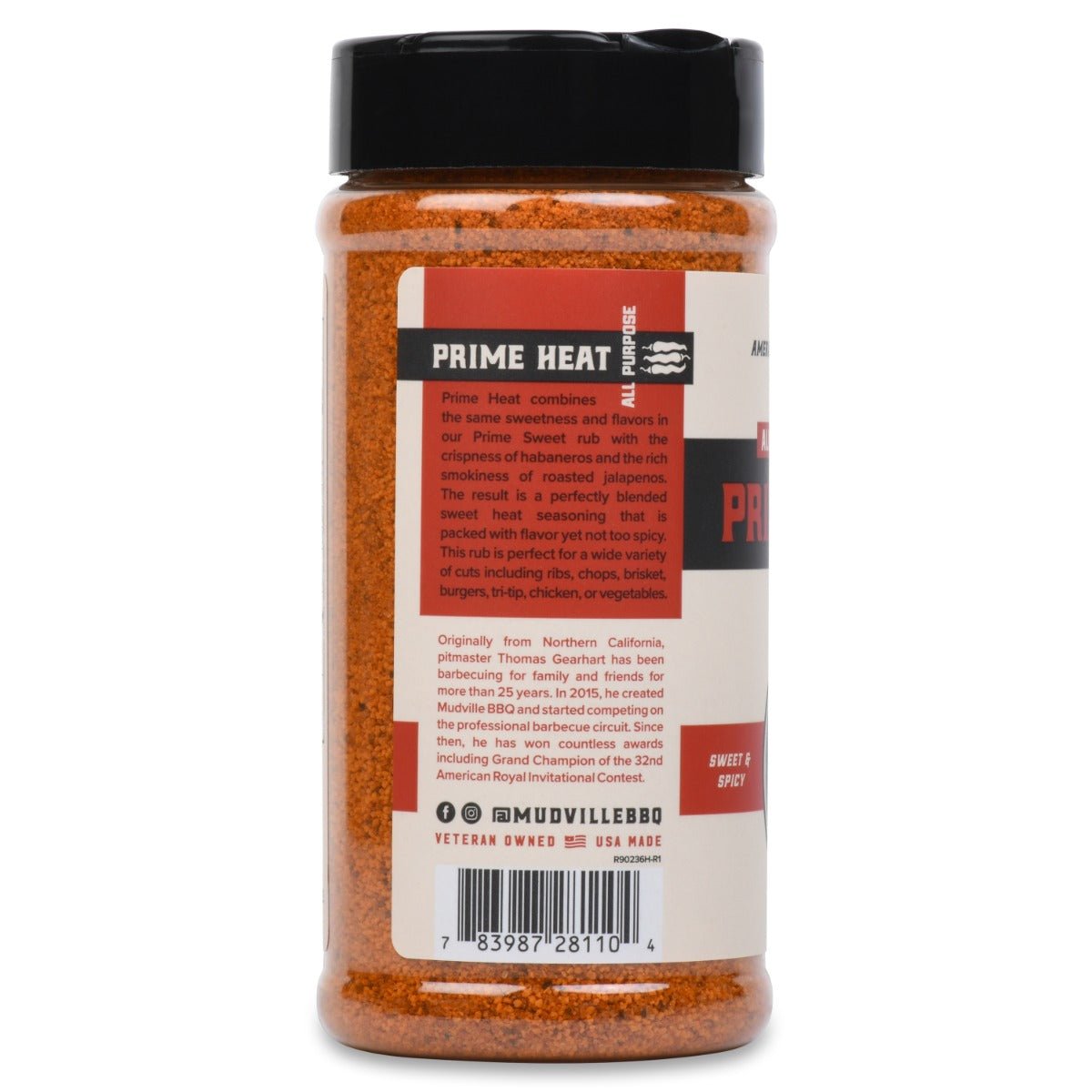 Rear view of a bottle of Mudville BBQ Prime Heat All Purpose Rub. The label describes the rub as a blend of sweet and spicy flavors, including habaneros and roasted jalapenos. The text mentions the rub's versatility for various cuts of meat and includes a brief bio of the pitmaster, Thomas Gearhart, with social media information and a barcode at the bottom.