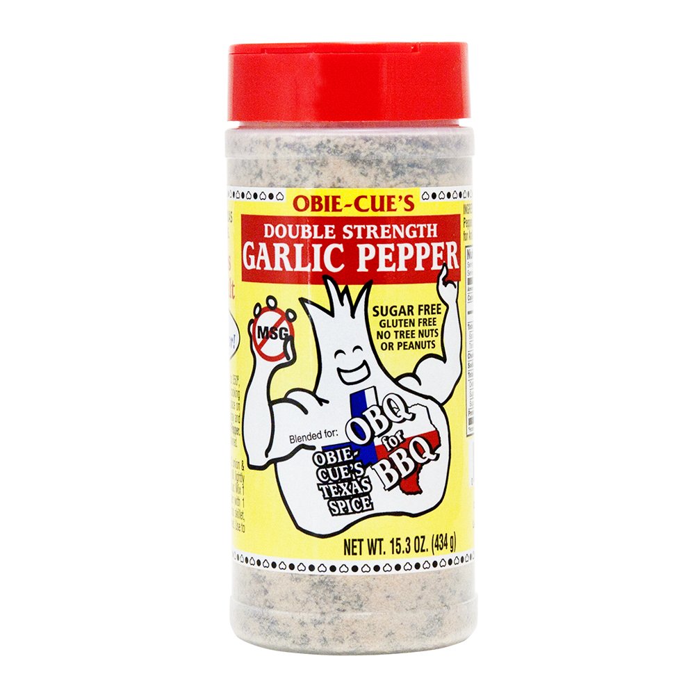 Front view of Obie-Cue's Double Strength Garlic Pepper bottle. The label features a cartoon garlic character and highlights the product as a sugar-free, gluten-free spice blend, suitable for BBQ, with no tree nuts or peanuts.