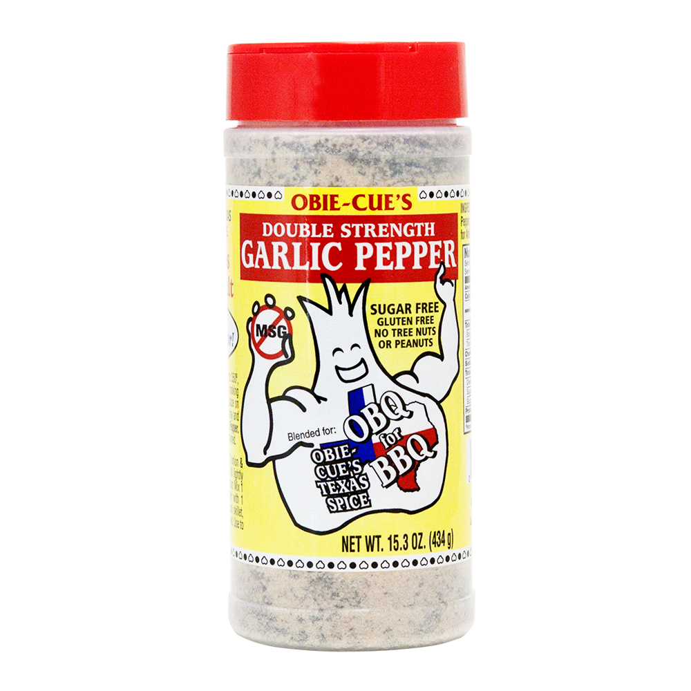 Front view of Obie-Cue's Double Strength Garlic Pepper bottle. The label features a cartoon garlic character and highlights the product as a sugar-free, gluten-free spice blend, suitable for BBQ, with no tree nuts or peanuts.