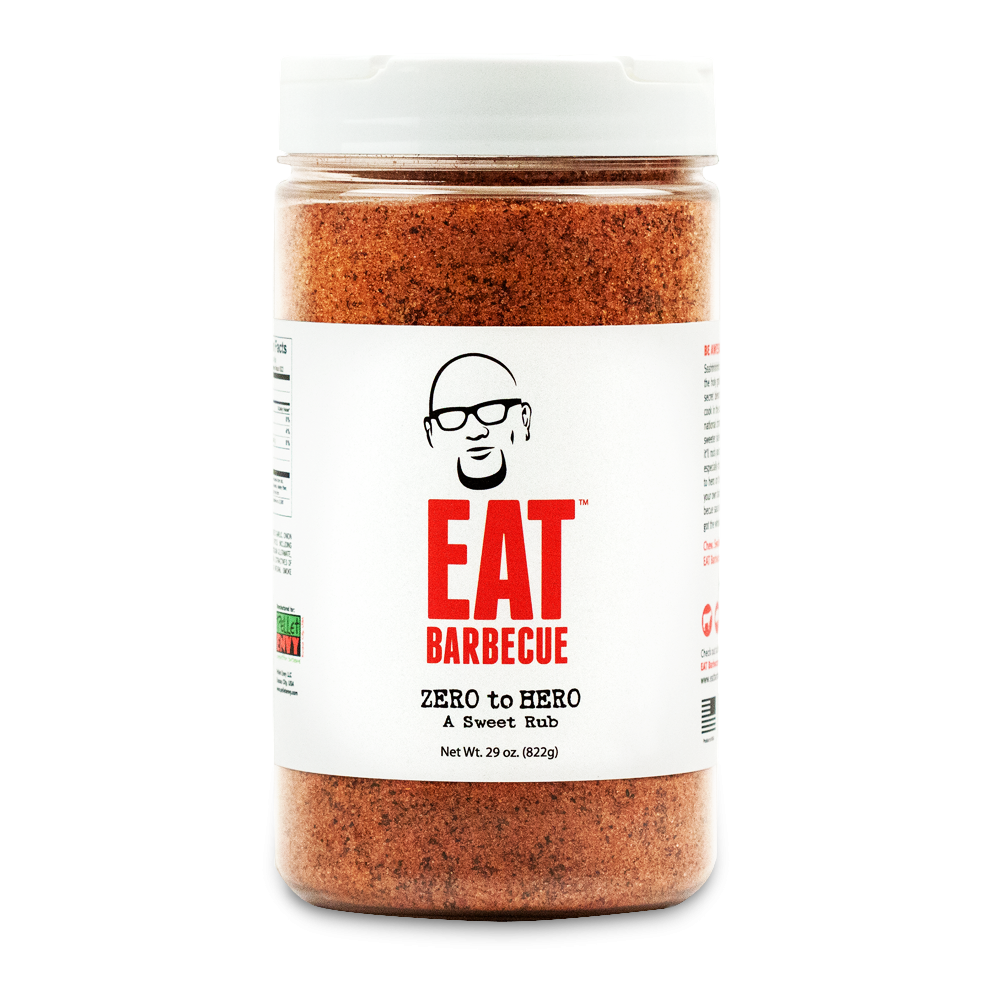 A 29-ounce container of EAT Barbecue Zero to Hero sweet rub with a white lid. The label features a stylized image of a man's face wearing glasses above the brand name "EAT Barbecue" in red text. The rub is labeled as "Zero to Hero A Sweet Rub.