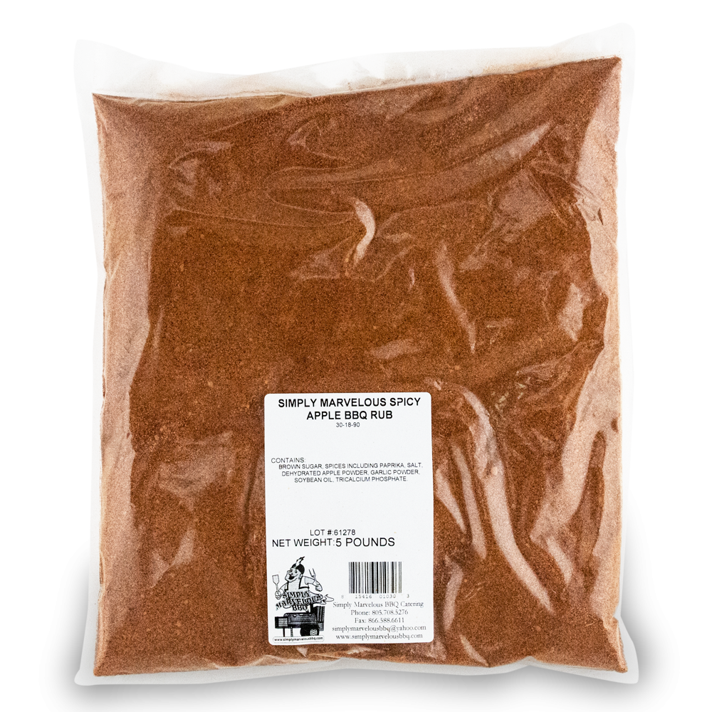 A large, clear plastic bag filled with a reddish-brown seasoning labeled 'Simply Marvelous Spicy Apple BBQ Rub.' The label lists ingredients including brown sugar, paprika, salt, dehydrated apple powder, garlic powder, and soybean oil. The net weight is 5 pounds. The label also features a barcode and the Simply Marvelous BBQ & Catering contact information.