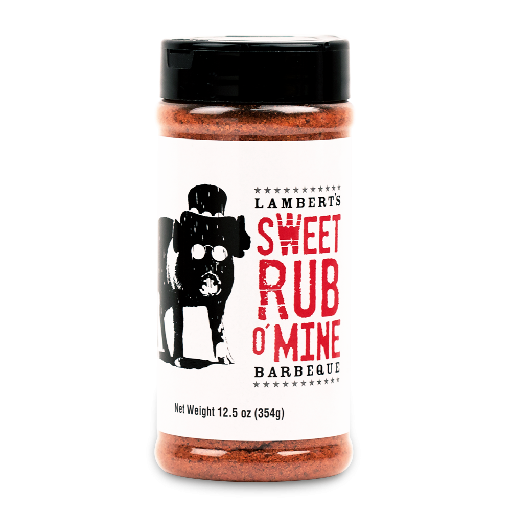 The front of a container of Lambert's Sweet Rub O' Mine Barbeque with a black cap. The label features a black and white illustration of a pig wearing sunglasses and a hat, alongside the product name in bold red and black text. The container holds 12.5 oz (354g) of seasoning.