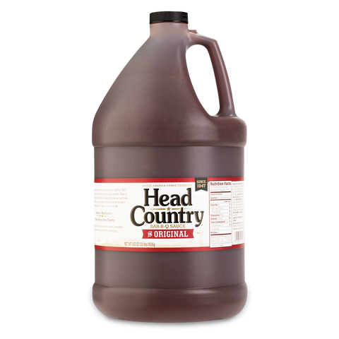 Bottle of Head Country's Original BBQ Sauce, renowned for "Winning Hearts & Championships Since 1947." This all-natural, gluten-free, tomato-based sauce is perfect for glazing, basting, or grilling any meat, promising a championship taste every time.