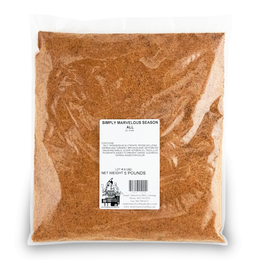 A large, clear plastic bag filled with a reddish-brown seasoning labeled 'Simply Marvelous Season All.' The label lists ingredients including salt, monosodium glutamate, spices, brown sugar, dehydrated onion and garlic, and more. The net weight is 5 pounds. The label also features a barcode and the Simply Marvelous BBQ & Catering contact information.