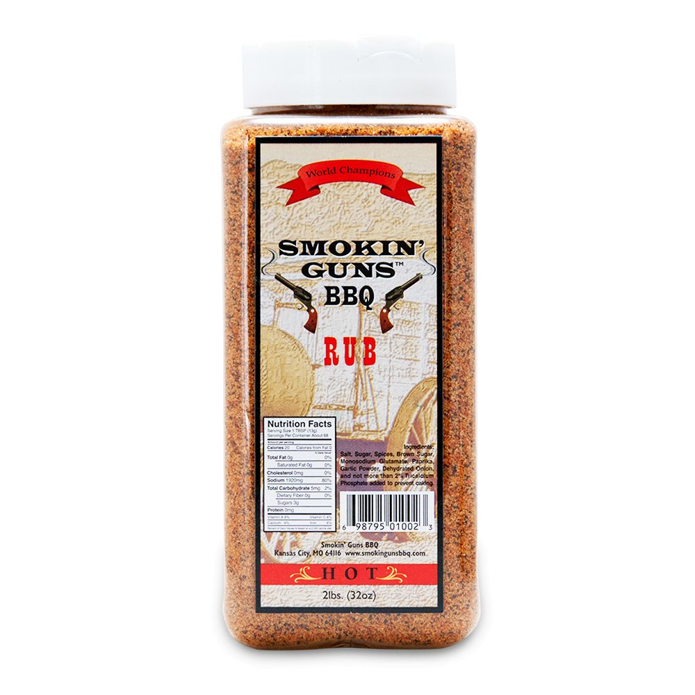 Close-up of a bottle of Smokin' Guns BBQ Rub with a vibrant label, showcasing the product's bold and smoky flavors. The bottle is set against a rustic wooden background, emphasizing its robust and savory seasoning perfect for grilling and BBQ dishes.