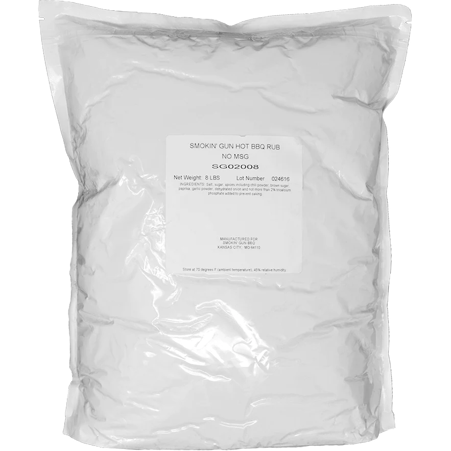 A large, sealed white bag containing 8 pounds of Smokin' Guns BBQ Hot Rub. The label reads "SMOKIN' GUN HOT BBQ RUB NO MSG" and lists ingredients such as salt, sugar, spices, chili powder, brown sugar, paprika, garlic powder, and dehydrated onion. The lot number is 024616, and the product is manufactured in Kansas City, MO.