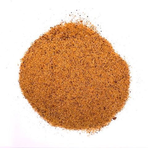 A heap of Sweet Money Hot Seasoning displayed on a white background. The seasoning is a rich, orange-brown color with visible granules of spices and herbs, suggesting a bold and spicy flavor profile.