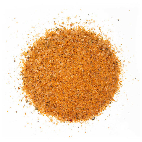 Close-up of Sweet Money Rub seasoning, a mixture of coarse and fine granules in natural tones.