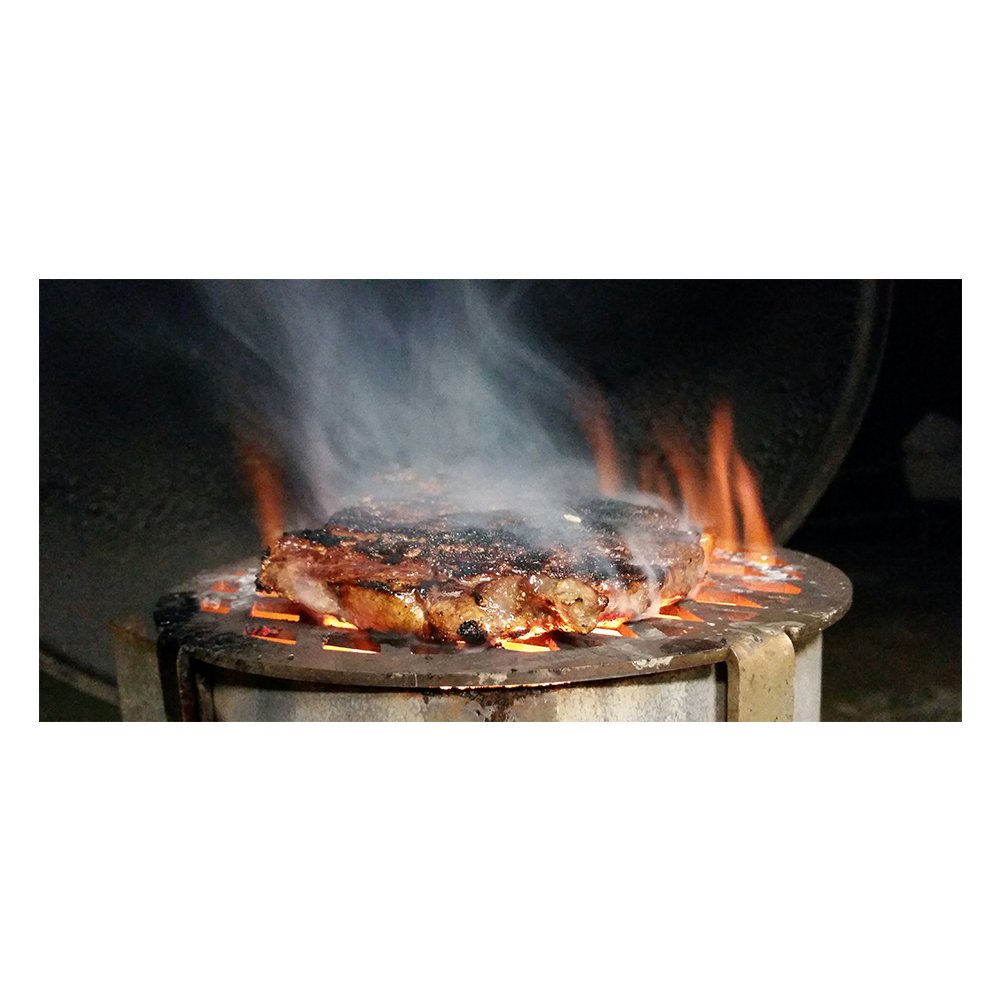 Unknown BBQ Chimney Griller, stainless steel accessory designed for grilling over a charcoal chimney, perfect for adding sear marks and enhancing BBQ flavor.  This image has a steak on the griller illustrating how to cook on the griller.