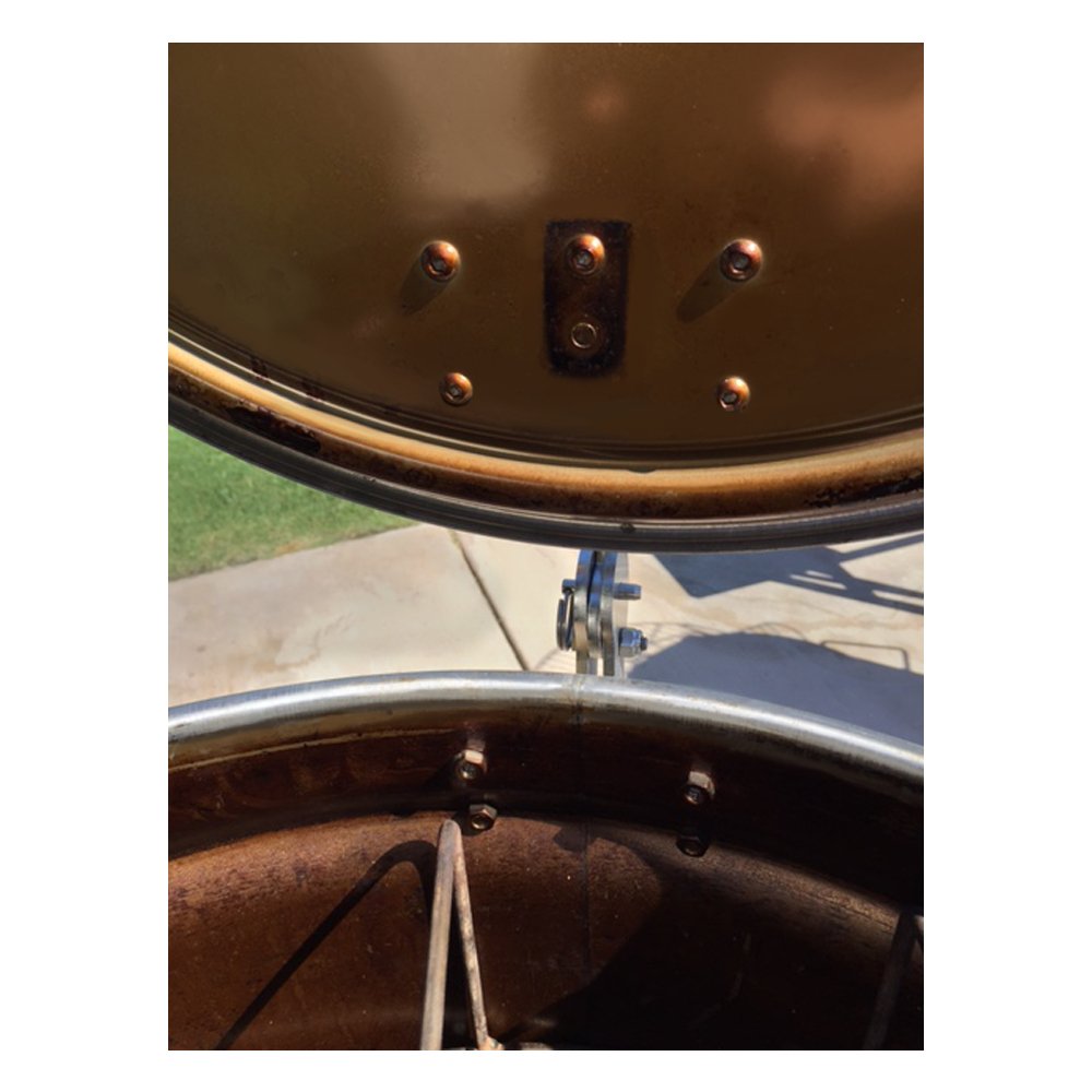 Close-up of Unknown BBQ Drum Smoker Lid Hinge on a 55-gallon drum smoker, showcasing its sturdy stainless steel construction and precise installation.  Close up is from inside of the drum with the lid open.